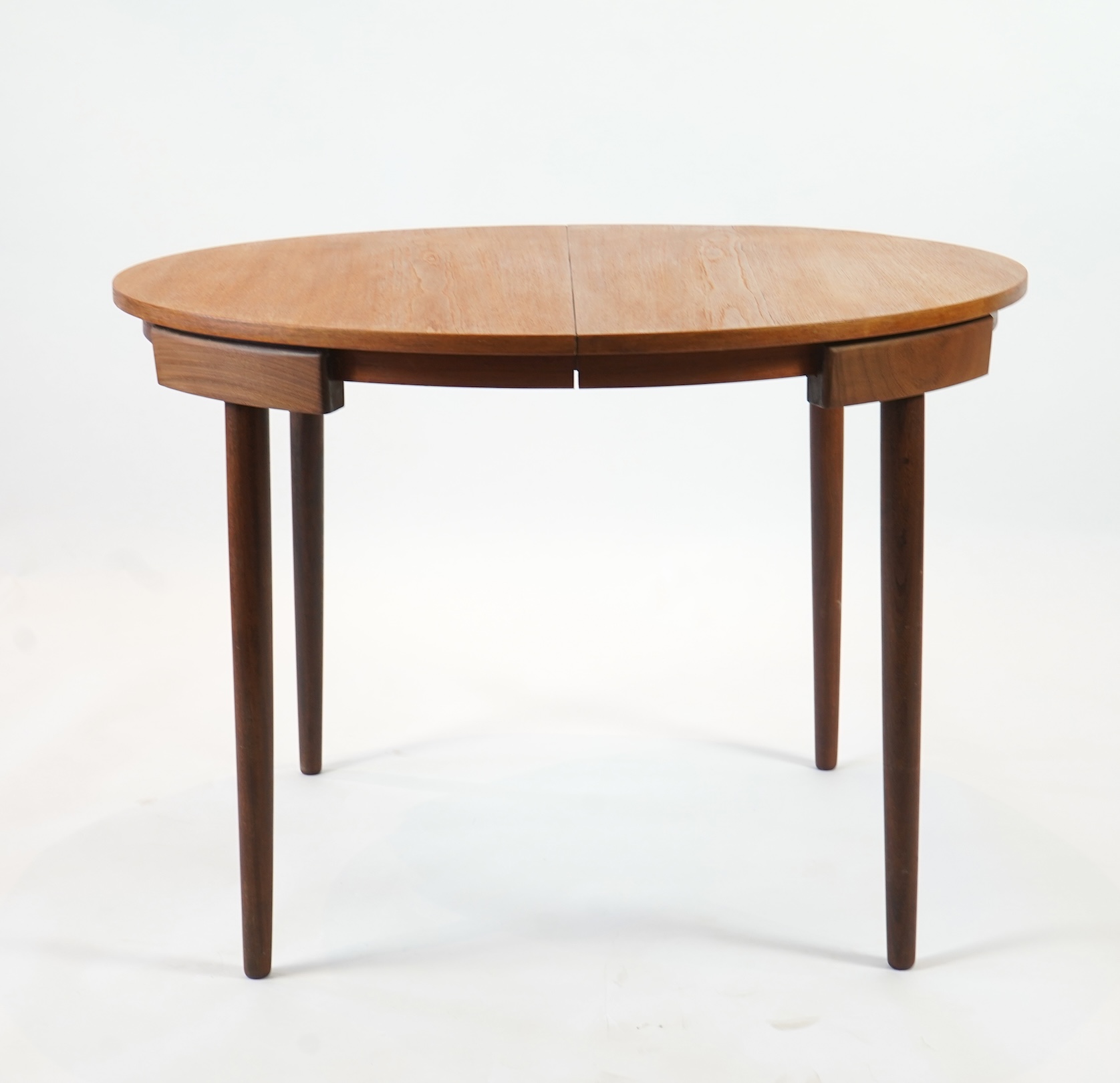 Hans Olsen (Danish, 1919–1992) for Frem Røjle: A Danish teak 'Roundette' extending dining table and six chairs